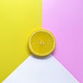 Minimal food concept. Lemon on a bright yellow-pink background. Free space for text. Top view. Minimalism. Creative citrus fruits