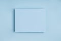 Minimal frame geometric composition mock up. Blank sheet of paper postcard on delicate blue.