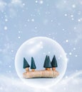 Minimal Happy New Year and Merry Christmas scene with snow, trees and snow globe. For Christmas holiday winter concept Royalty Free Stock Photo