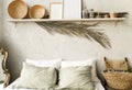 Minimal home interior bedroom design in boho style. Pillows, blanket and decorations