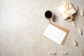 Minimal home office desk workspace with blank paper card, kraft envelope, coffee cup, gift box, dry flowers. Flat lay, top view Royalty Free Stock Photo