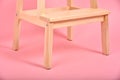 Minimal interior style, Detail of wood chair leg on pastel pink background Royalty Free Stock Photo