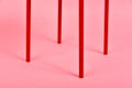 Minimal interior style, Detail of red metal chair leg on pastel pink background. Royalty Free Stock Photo