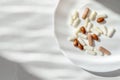 Minimal lifestyle aesthetic medicine concept. White and brown pills and capsules on white plate and marble table background with