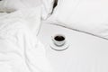 Minimal mornings with a cup of coffee in bed Royalty Free Stock Photo