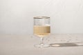 Minimal New Year celebration concept, one wineglass with sparkling wine on beige linen tablecloth background with Royalty Free Stock Photo