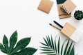 Minimal Office desk table with stationery set, supplies and palm leaves. Royalty Free Stock Photo