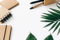 Minimal Office desk table with stationery set, supplies and palm leaves. Royalty Free Stock Photo