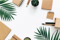 Minimal Office desk table with stationery set, supplies and palm leaves. Royalty Free Stock Photo