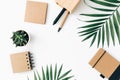 Minimal Office desk table with stationery set, supplies and palm leaves Royalty Free Stock Photo
