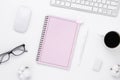 Minimal Office desk table top view with pink notebook blank pages, Keyboard computer, mouse, coffee cup on a white table with copy Royalty Free Stock Photo