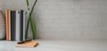 Minimal office room with office supplies and copy space on white wooden table and white brick wall