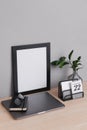 Minimal Office with mini calendar, portrait and laptop in gray background mockup