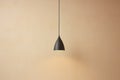 minimal pendant light fixture against a neutral wall Royalty Free Stock Photo
