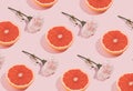 Minimal romatic pattern made with pink flowers and grapefruit on pastel background. Creative spring romance composition