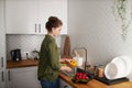 Minimal side view woman washing vegetables in kitchen Royalty Free Stock Photo