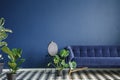 Minimal style interior with big dark blue couch standing on a ch