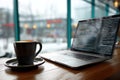 Minimal Tech Startup Workspace Featuring a Laptop, Coffee, and Code Window in a Modern Cafe Setting During the Daytime Royalty Free Stock Photo