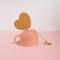 Minimal trendy coffee break concept with cup, coaster and teaspoon on pastel pink background. Modern, romantic aesthetic