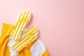 Minimal trendy vacation essentials concept. Top view flat lay of yellow striped flip-flops, towel on pastel pink background with Royalty Free Stock Photo