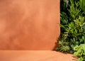 Minimal tropical podium with orange beige background and green garden exposition.