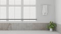 Minimal white and clean bathroom with a towel hanging on the towel rack, window with window blinds Royalty Free Stock Photo