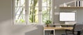 Minimal white home office with computer mockup on wood table, window with nature view Royalty Free Stock Photo