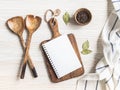 Minimal white kitchen background with blank notebook for text, cutting board, cotton napkin and various spices Royalty Free Stock Photo