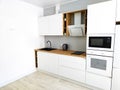 White kitchen scandinavian interior with cooker hood on wooden countertop Royalty Free Stock Photo