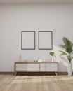 Minimal white living room with decor on wood cabinet, frames mockup on white wall Royalty Free Stock Photo