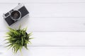 Office desk wooden table with old camera. Top view with copy space. Top view of old camera over wooden table. Retro vintage filter Royalty Free Stock Photo