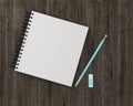 Minimal work space : notebook with blue pencil, eraser on wooden Royalty Free Stock Photo