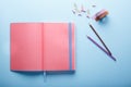 Minimal work space : pink sketchbook and pencils on blue background. Top view , flat lay Royalty Free Stock Photo