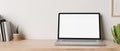 Minimal working desk with opened notebook laptop mockup over white wall