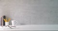 Minimal workplace with coffee cup, glasses, notebook and pencil holder on white table. Copy space for your text Royalty Free Stock Photo