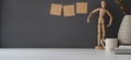 Minimal workspace with copy space and decorations on white table and dark grey wall Royalty Free Stock Photo