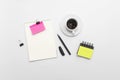 Minimal workspace with notebook, colorful sticky notes, pen, binder clips and coffee cup on white background, top view Royalty Free Stock Photo