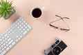 Minimal workspace with technology equipment on pastel pink background
