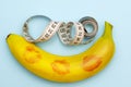 Minimalism, a banana in lipstick from kissing next to a measuring tape, size does matter Royalty Free Stock Photo