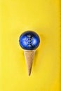 Minimalism. Blue Christmas ball on a cone for ice cream. Concept: Christmas, New Year. Royalty Free Stock Photo