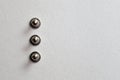 minimalism close-up three grommet, rivet, snap, button on the paper silver background