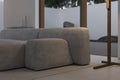 Minimalism and constructivism concept. Beige design comfortable couch near big terrace.