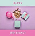 Minimalism. Happy Birthday. Gift blue box, balloon and decorative colored elements on a lilac background. A mock-up of a greeting