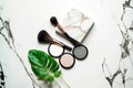 Minimalism mineral cosmetics eyeshadow cosmetic powder and blush on marble table