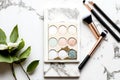 Minimalism mineral cosmetics eyeshadow cosmetic powder and blush on marble table