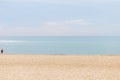 Minimalism photo. Beach, sky and sea line. One woman in sea cloth.