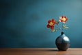 minimalism photo modern vase with orange flowers on a table with copy space on blue background Royalty Free Stock Photo