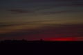 Minimalism photo with tree in middle during red sunset with amazing sky, suitable for background