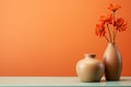 minimalism photo two modern ceramic vases with orange flowers on a table with copy space on orange background Royalty Free Stock Photo