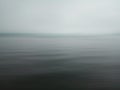 Misty morning background in the sea. Fog over lake wave water. Calm beach view. Tranquil empty nature landscape with gloomy sky.